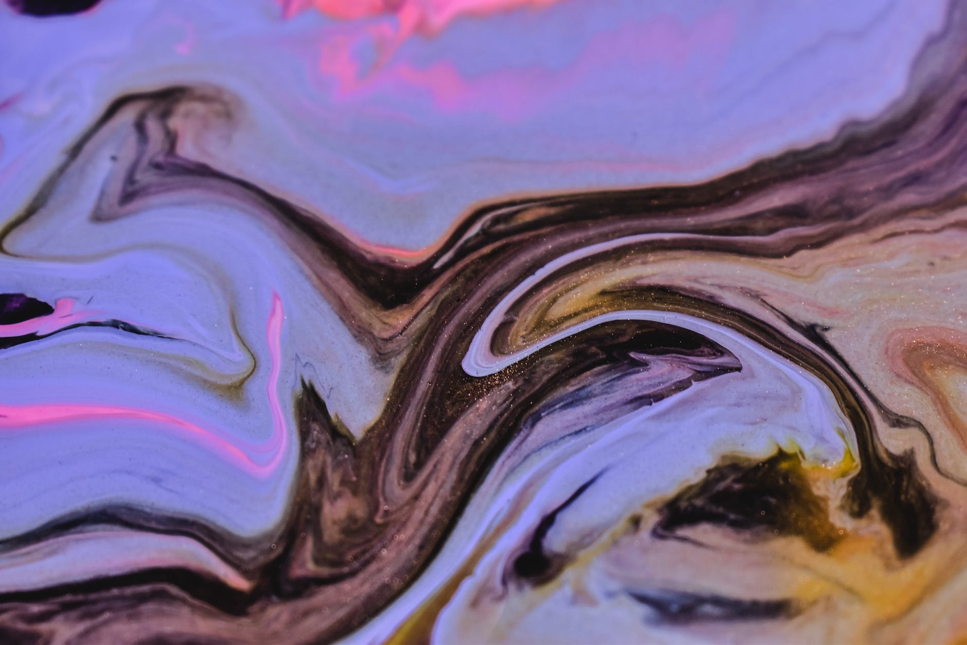 mix of multicolored paints swirling on uneven surface